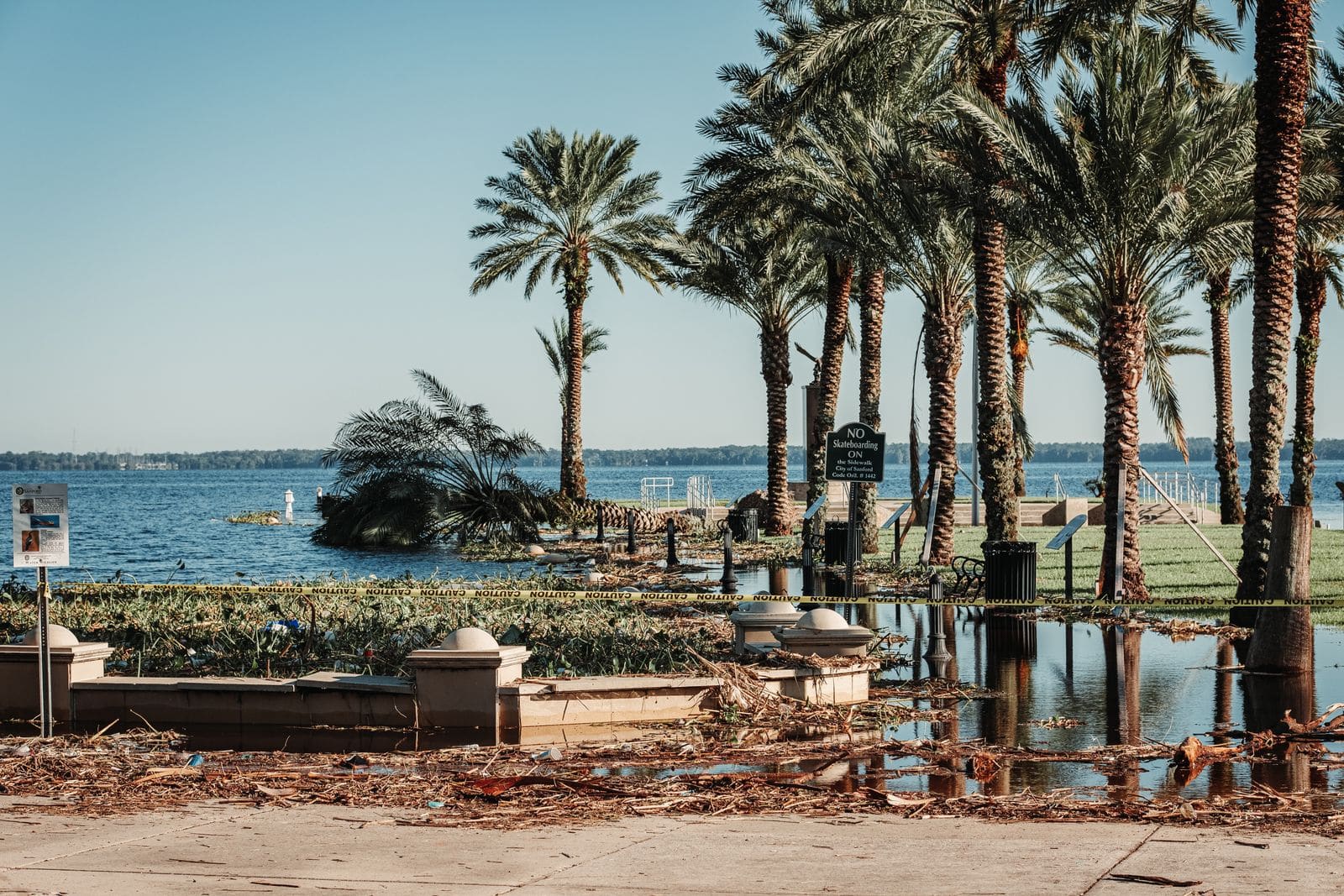 Storm debris and standing water along a Florida waterfront after a hurricane